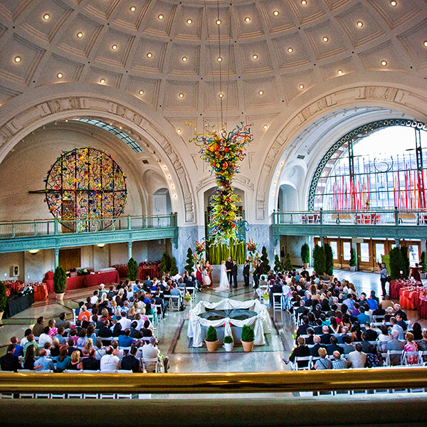 Tacoma wedding planning photo showing a wedding ceremony in Tacoma Union Station being witnessed by several hundred guests.