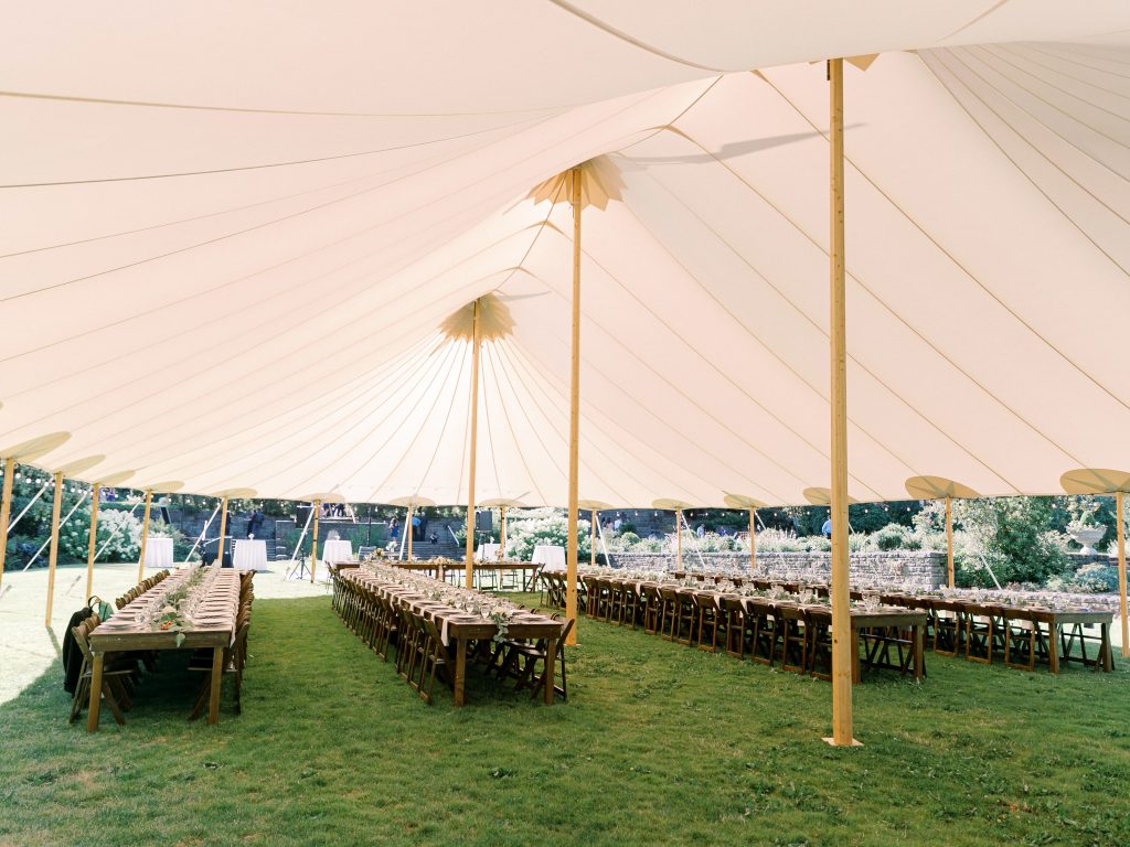 long tables underneath a wedding tent wedding marquee