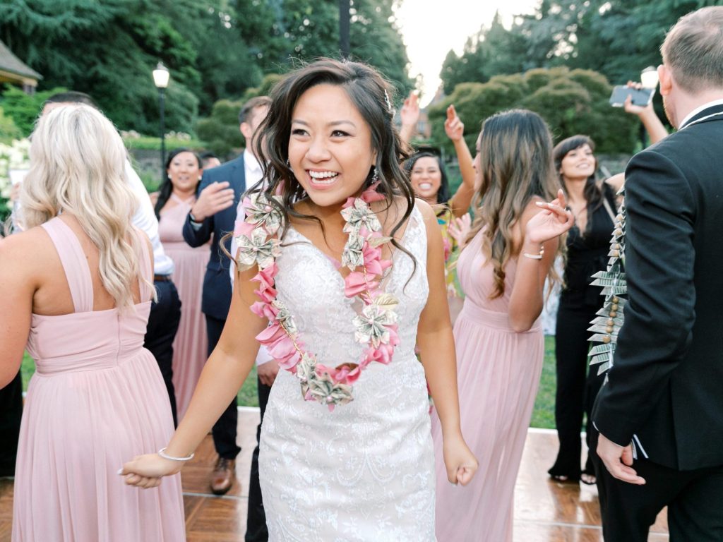 happy dancing bride wearing a lei of flowers