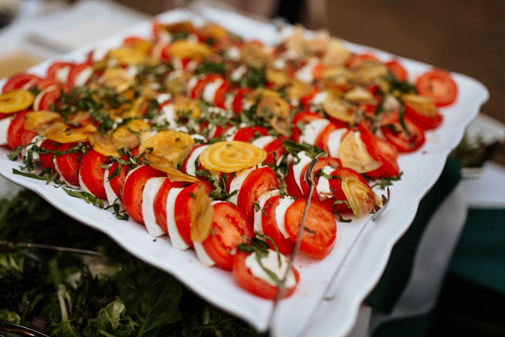 feeding vegetarians at events: platter of fresh tomatoes, goat cheeses, herbs, and crackers