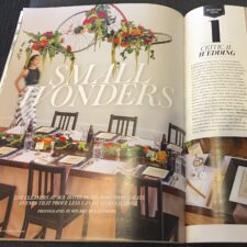 photograph of a wedding magazine open to a page called Small Wonders with a photo of a beautiful wedding tabletop