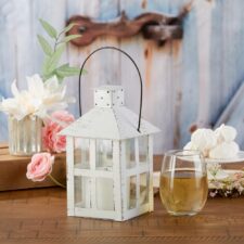 a small white lantern for wedding decor