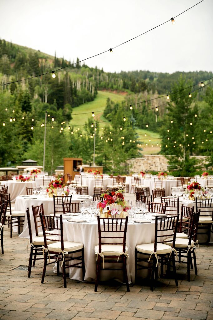 Outdoor photo of round tables with floral centerpieces