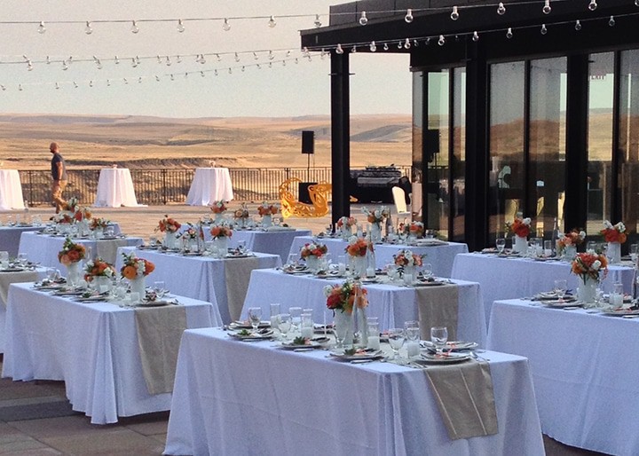 Place-set, draped tables outdoor, with a view of the Columbia Gorge